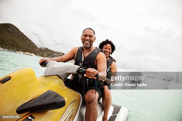 couple on jetski - saint martin caraibi stock-fotos und bilder