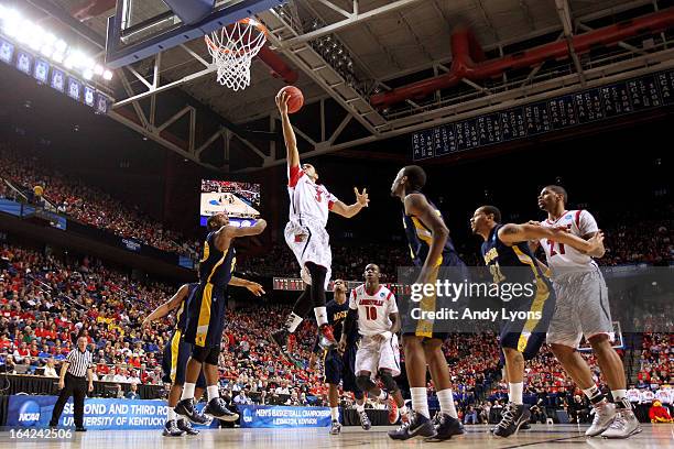 Peyton Siva of the Louisville Cardinals goes to the hoop against the North Carolina A&T Aggies during the second round of the 2013 NCAA Men's...