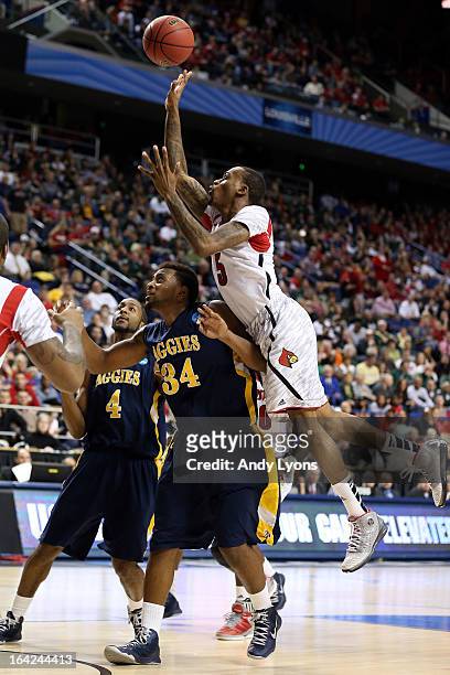 Kevin Ware of the Louisville Cardinals goes to the hoop against Bruce Beckford of the North Carolina A&T Aggies during the second round of the 2013...