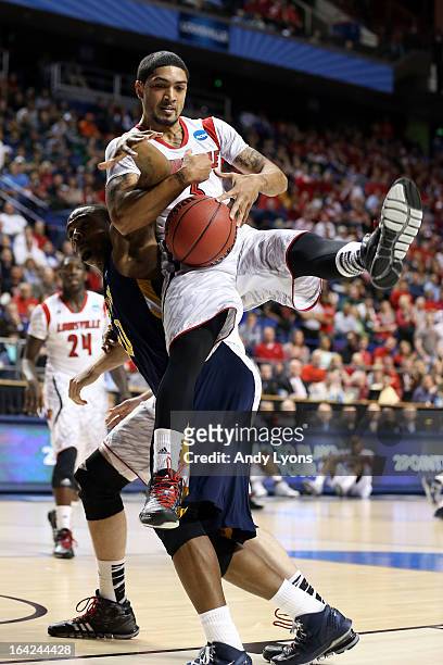 Peyton Siva of the Louisville Cardinals rebounds against Lamont Middleton of the North Carolina A&T Aggies during the second round of the 2013 NCAA...