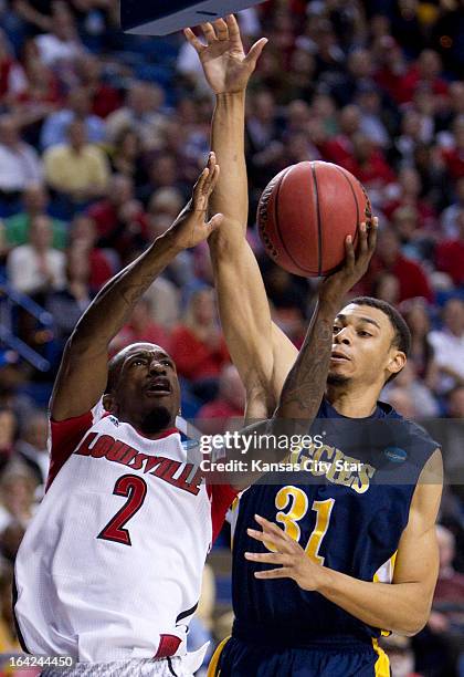 Louisville's Russ Smith gets a step on North Carolina A&T's Austin Witter while driving for a basket in the first half in the NCAA Tournament...