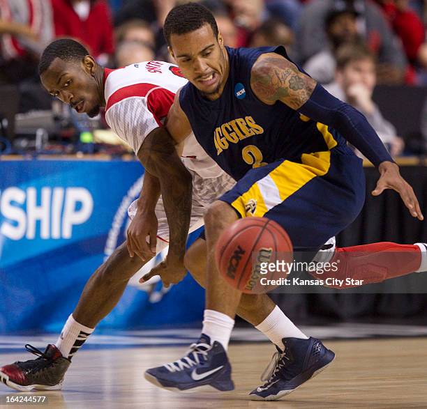 North Carolina A&T's Jeremy Underwood reacts as he loses his dribble against Louisville's Peyton Siva in the first half in the NCAA Tournament...