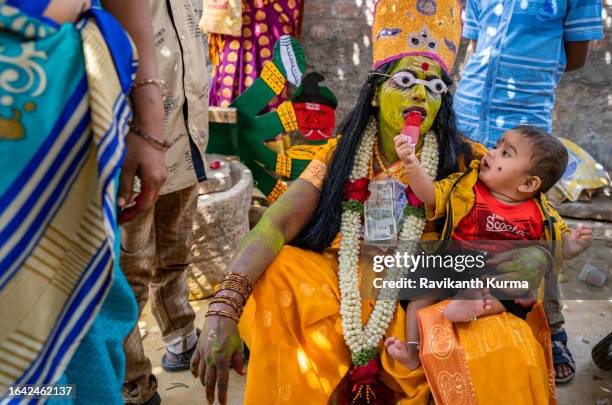 a relaxed moment while the baby is being payfull with mom's kali accessories. - kaveripattinam stock pictures, royalty-free photos & images