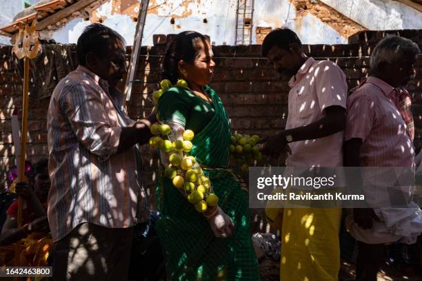 a devoee getting lemons pierced over her hands. - kaveripattinam stock pictures, royalty-free photos & images