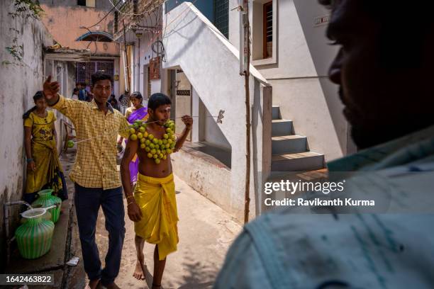 a devotee with lemons stitched on his body heading to temple to offer his prayers. - kaveripattinam stock pictures, royalty-free photos & images