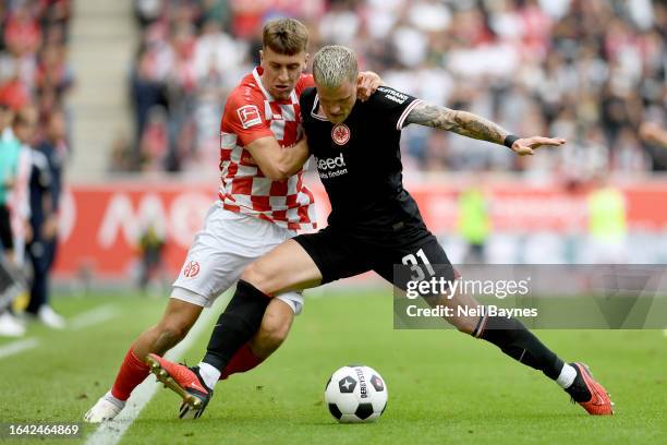 Brajan Gruda of 1.FSV Mainz 05 battles for possession with Philipp Max of Eintracht Frankfurt during the Bundesliga match between 1. FSV Mainz 05 and...