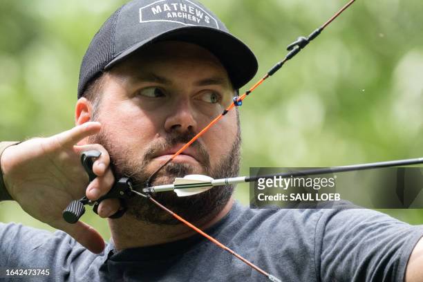 Taylor Chamberlin, an urban deer hunter with the goal of dealing with overpopulation in urban areas, practices with his bow in the backyard of his...