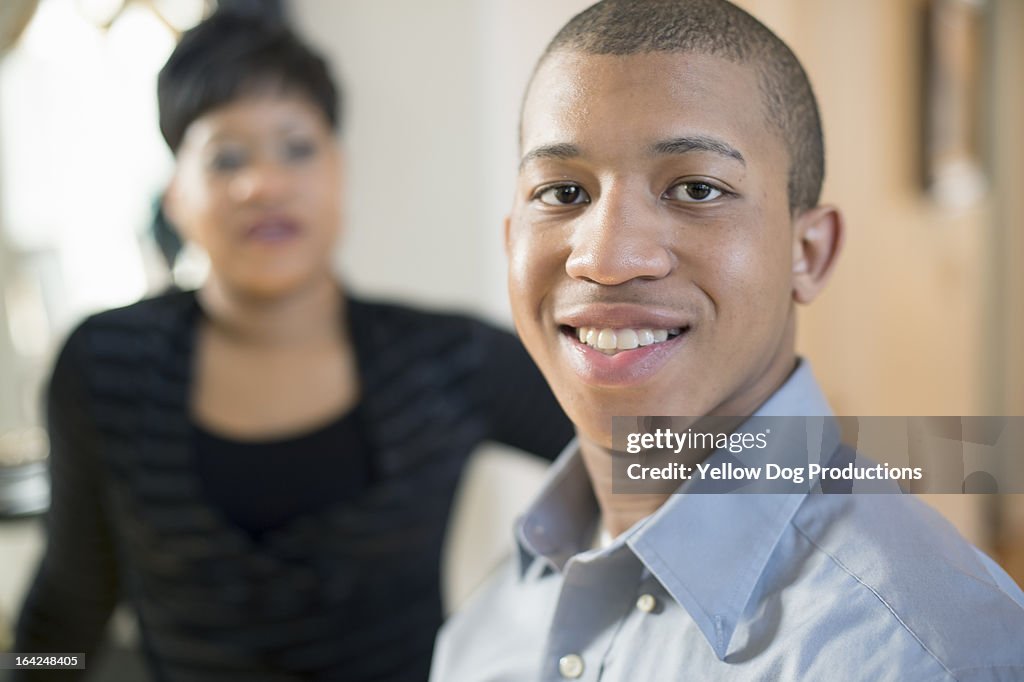 Portrait of Smiling Teen, Mom in background