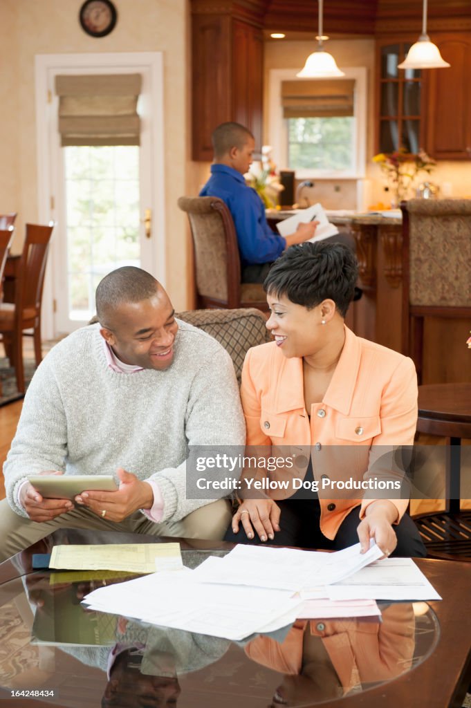 Parents in living room working on finances