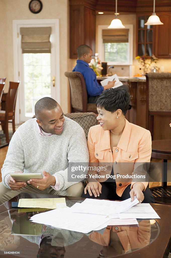 Parents in living room working on finances