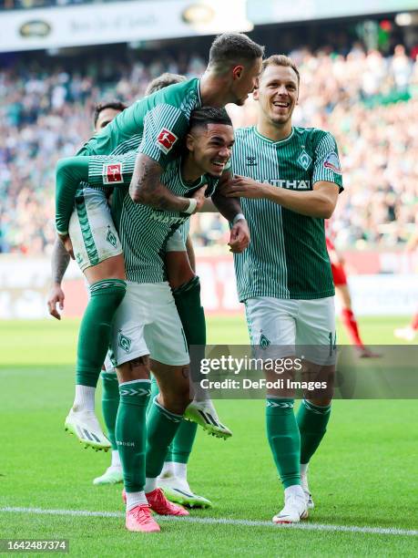 Justin Njinmah of SV Werder Bremen celebrates his goal with team mates during the Bundesliga match between SV Werder Bremen and 1. FSV Mainz 05 at...