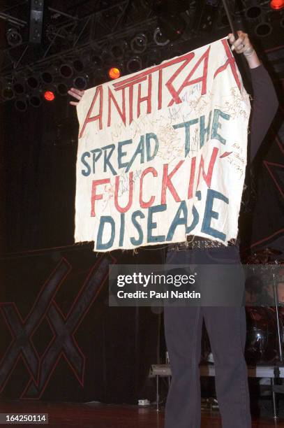 American singer Joey Belladonna of the band Anthrax holds up a signed, fan-made banner on stage at the House of Blues, Chicago, Illinois, May 1,...