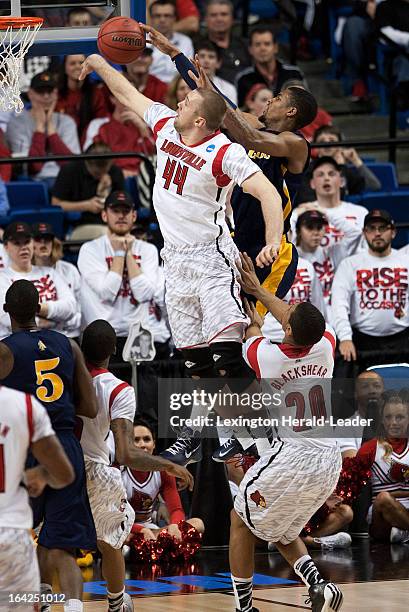 Louisville's Stephan Van Treese, left, blocks a shot by North Carolina A&T's Adrian Powell in the first half in the NCAA Tournament second-round game...
