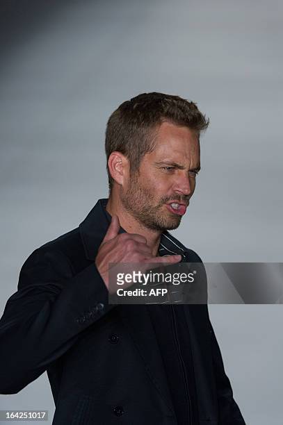 American actor Paul Walker presents a creation by Colcci during the 2013 Summer collections of the Sao Paulo Fashion Week in Sao Paulo, Brazil, on...