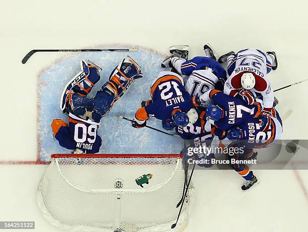The New York Islanders and the Montreal Canadiens pile up after Gabriel Dumont ran into Evgeni Nabokov at the Nassau Veterans Memorial Coliseum on...