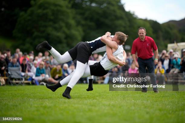 Competitors take part in traditional Cumberland and Westmorland Style wrestling during the Grasmere Lakeland Sports and Show on August 27, 2023 in...