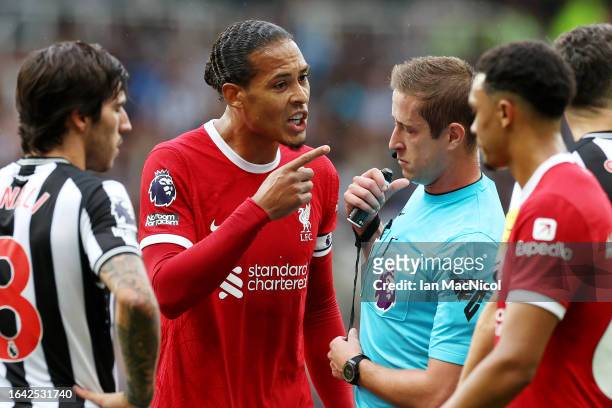 Virgil van Dijk of Liverpool interacts with Referee John Brooks during the Premier League match between Newcastle United and Liverpool FC at St....