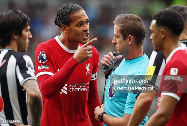 Virgil van Dijk of Liverpool reacts after being shown a red card by referee John Brooks during the Premier League match between Newcastle United and...