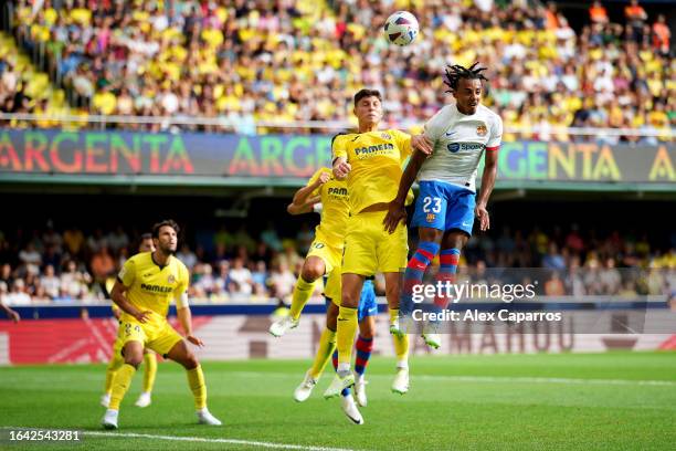 Jorge Cuenca of Villarreal and Jules Kounde of FC Barcelona battle for a header during the LaLiga EA Sports match between Villarreal CF and FC...