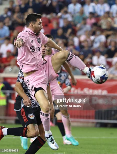 Lionel Messi of Inter Miami CF jumps for the ball in the second half during a match between Inter Miami CF and New York Red Bulls at Red Bull Arena...