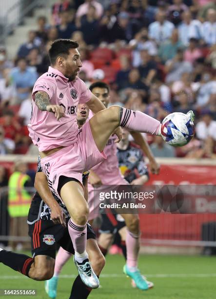 Lionel Messi of Inter Miami CF jumps for the ball in the second half during a match between Inter Miami CF and New York Red Bulls at Red Bull Arena...