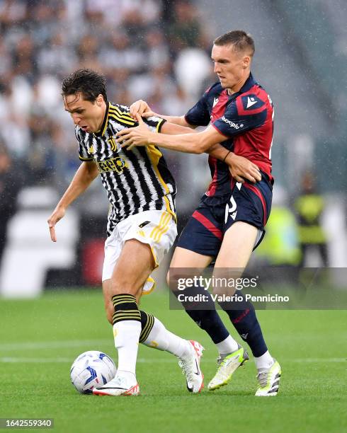 Federico Chiesa of Juventus challenges for the ball with Michel Aebischer of Bologna during the Serie A TIM match between Juventus and Bologna FC on...