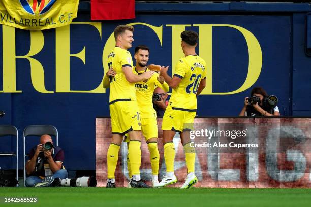 Alex Baena of Villarreal celebrates with teammates Alexander Soerloth and Ramon Terrats after scoring the team's third goal during the LaLiga EA...