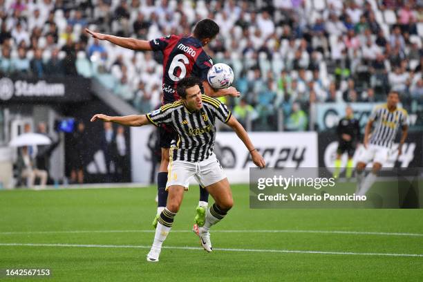Federico Chiesa of Juventus and Nikola Moro of Bologna FC battle for the ball during the Serie A TIM match between Juventus and Bologna FC at Allianz...