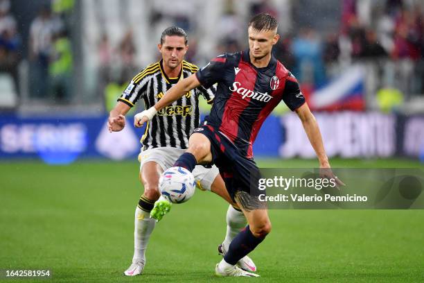 Stefan Posch of Bologna controls the ball ahead of Adrien Rabiot of Juventus during the Serie A TIM match between Juventus and Bologna FC at Allianz...