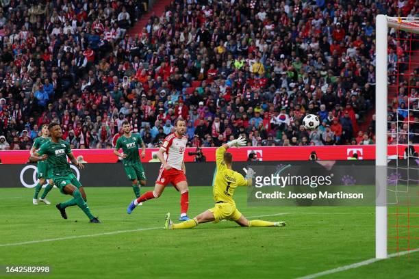 Harry Kane of Bayern Munich scores the team's third goal during the Bundesliga match between FC Bayern München and FC Augsburg at Allianz Arena on...