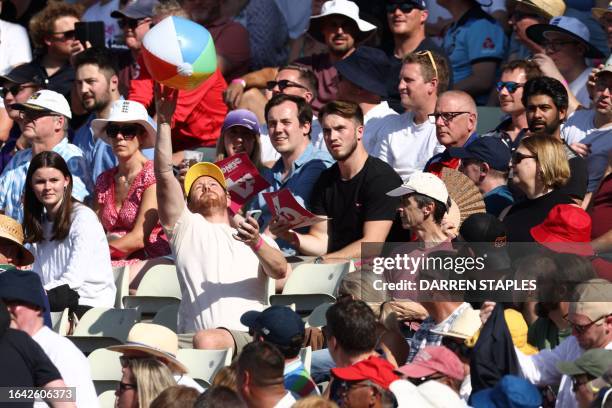 Fans play with beach ball in the crowd during the third T20 international cricket match between England and New Zealand at Edgbaston, in Birmingham,...