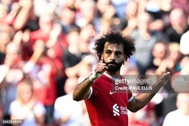 Liverpool's Egyptian striker Mohamed Salah celebrates after scoring his team third goal during the English Premier League football match between...