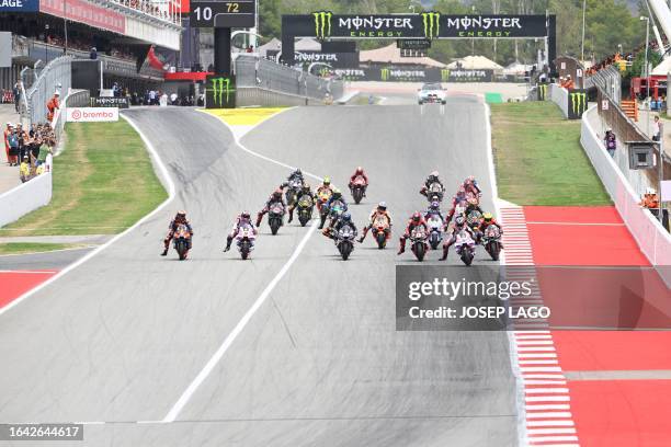 Riders take a second start after a mass fall during the MotoGP race of the Moto Grand Prix de Catalunya at the Circuit de Catalunya in Montmelo, on...