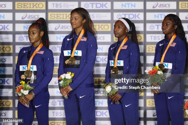 Gold medalists Sha'Carri Richardson, Gabrielle Thomas, Twanisha Terry and Tamari Davis of Team United States pose for a photo on the podium during...