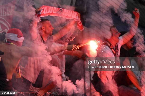 Cologne fans cheer during the German first division Bundesliga football match between Eintracht Frankfurt and FC Cologne in Frankfurt am Main,...