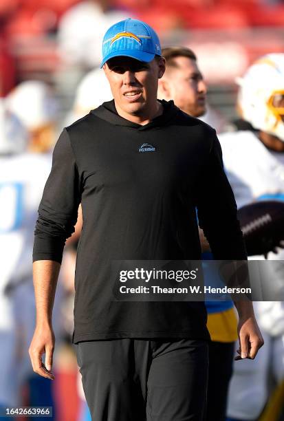 Offensive coordinator Kellen Moore of the Los Angeles Chargers looks on during pregame warm ups prior to playing the San Francisco 49ers in a...