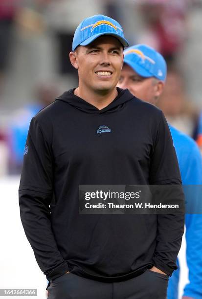 Offensive coordinator Kellen Moore of the Los Angeles Chargers looks on during pregame warm ups prior to playing the San Francisco 49ers in a...