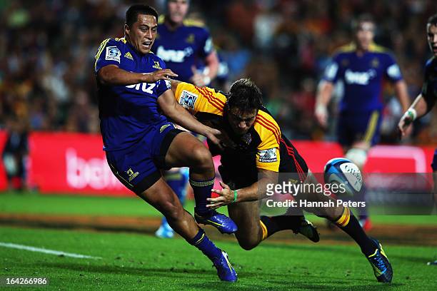 Richard Kahui of the Chiefs tackles Jason Emery of the Highlanders during the round six Super Rugby match between the Chiefs and the Highlanders at...