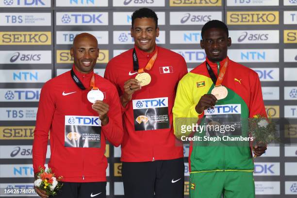 Silver medalist Damian Warner of Team Canada, Gold medalist Pierce Lepage of Team Canada, and Bronze medalist Lindon Victor of Team Grenada pose for...