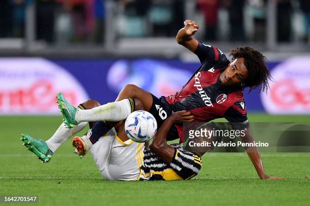 Alex Sandro of Juventus clashes with Joshua Zirkzee of Bologna during the Serie A TIM match between Juventus and Bologna FC at Allianz Stadium on...