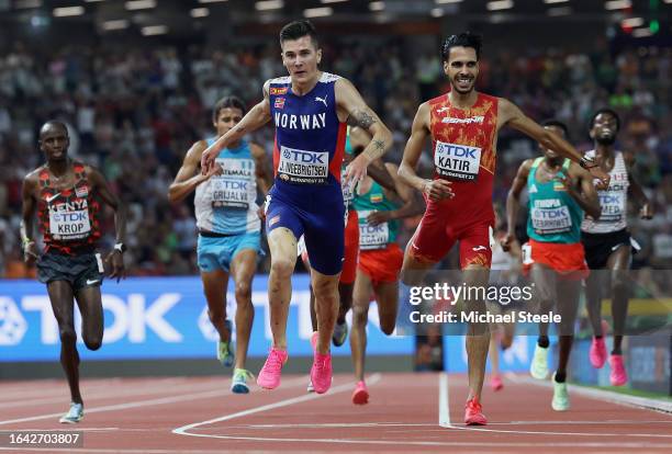 Jakob Ingebrigtsen of Team Norway and Mohamed Katir of Team Spain cross the finish line of the Men's 5000m Final during day nine of the World...