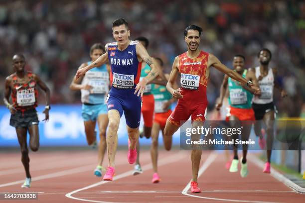 Jakob Ingebrigtsen of Team Norway and Mohamed Katir of Team Spain cross the finish line of the Men's 5000m Final during day nine of the World...