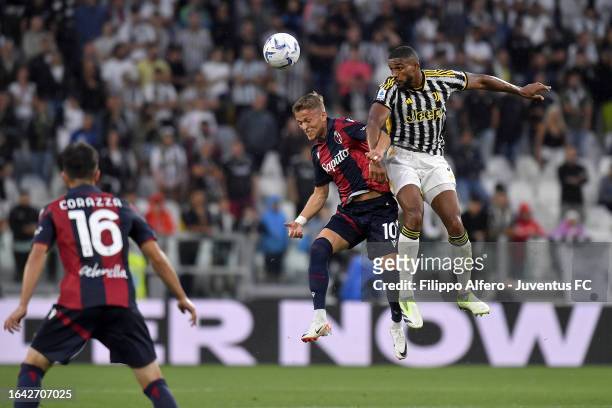 Gleison Bremer of Juventus jumps for the ball against Karl Karlsson of Bologna FC during the Serie A TIM match between Juventus and Bologna FC at...