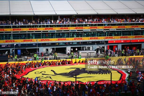 Fans display a Ferrari flag during the Italian Formula One Grand Prix race at Autodromo Nazionale Monza circuit, in Monza on September 3, 2023.