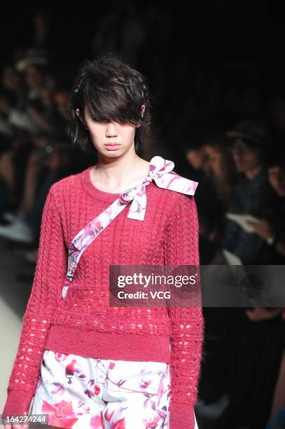 Model showcases designs on the runway at the Tiit show during Mercedes Benz Fashion Week Tokyo Autumn/Winter 2013/14 at Shibuya Hikarie Hikari Hall B...