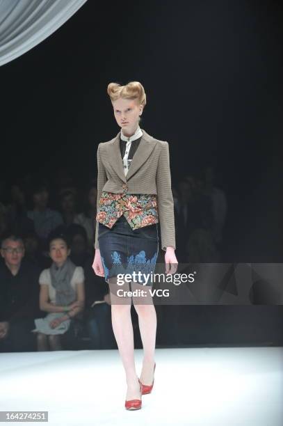 Model showcases designs on the runway at the Motonsri Ono show during Mercedes Benz Fashion Week Tokyo Autumn/Winter 2013/14 at Shibuya Hikarie...