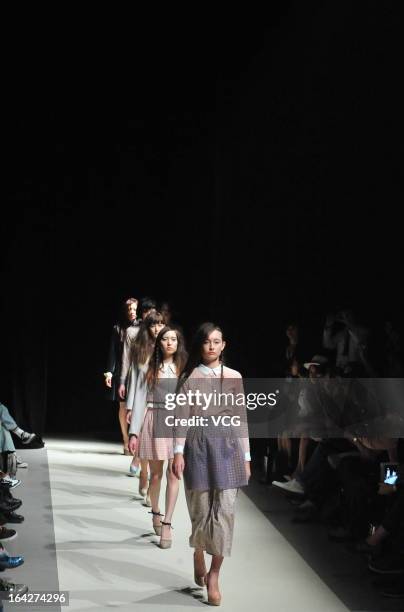 Models showcase designs on the runway at the Tiit show during Mercedes Benz Fashion Week Tokyo Autumn/Winter 2013/14 at Shibuya Hikarie Hikari Hall B...