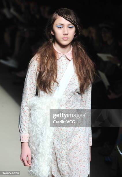 Model showcases designs on the runway at the Tiit show during Mercedes Benz Fashion Week Tokyo Autumn/Winter 2013/14 at Shibuya Hikarie Hikari Hall B...