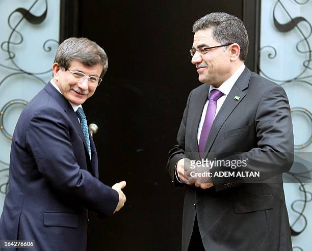 Turkish Foreign minister Ahmet Davutoglu welcomes Syrian opposition prime minister Ghassan Hitto prior to a meeting in Ankara, on March 22, 2013. In...