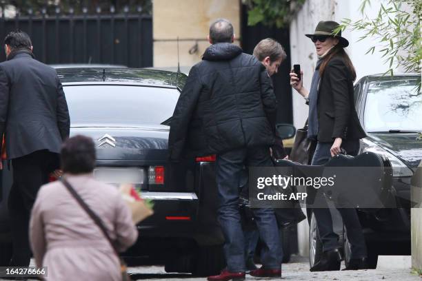 Former French First Lady Carla Bruni-Sarkozy arrives at her shared home with French former president Nicolas Sarkozy on March 22, 2013 in Paris, a...